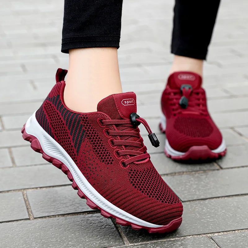 Person wears new maroon sport sneakers with a toggle-lace system.
