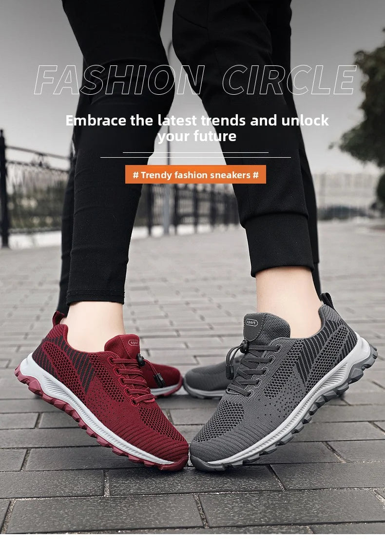 Shows off a pair of trendy fashion sneakers, one gray and one burgundy, worn on a paved surface, promoting comfortable and stylish footwear.
