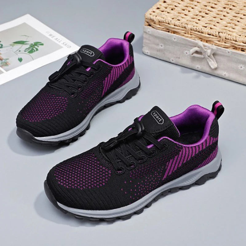 Close-up shows stylish black and purple sport sneakers featuring convenient bungee laces.
